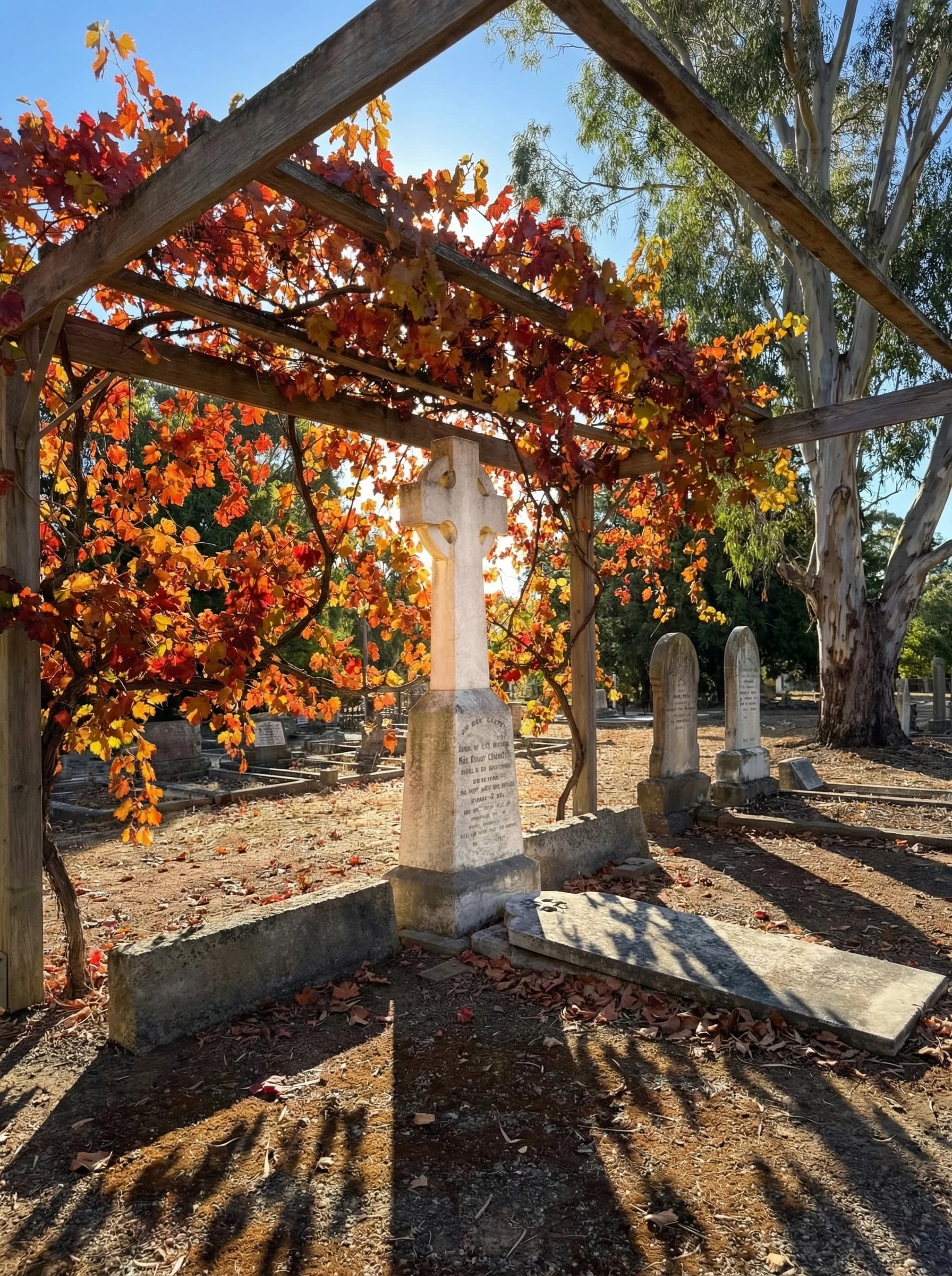 Celtic cross beside the autumn vine pergola